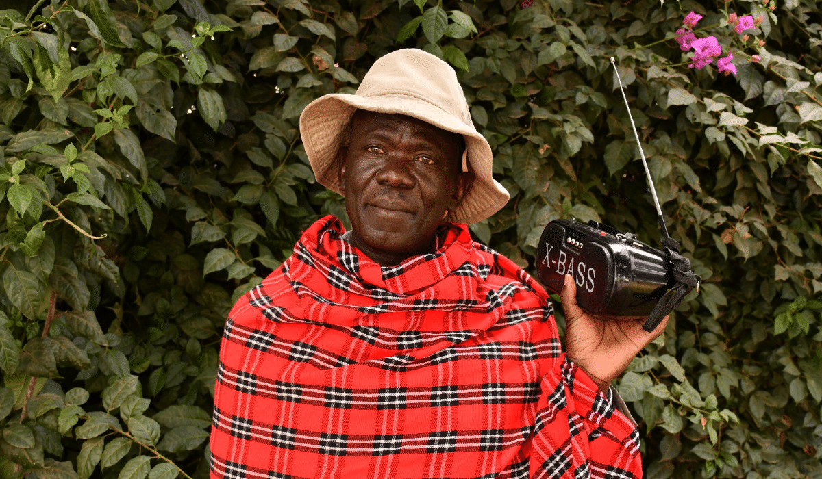 A Kenyan man listens to an analog radio set