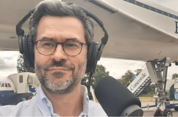 A picture of Pedro Mendes wearing headphones and smiling
