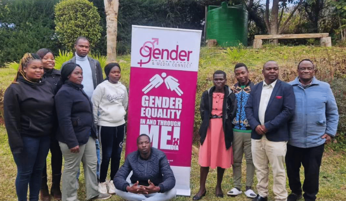 A group of people around a banner which reads "Gender Equality in and through media"