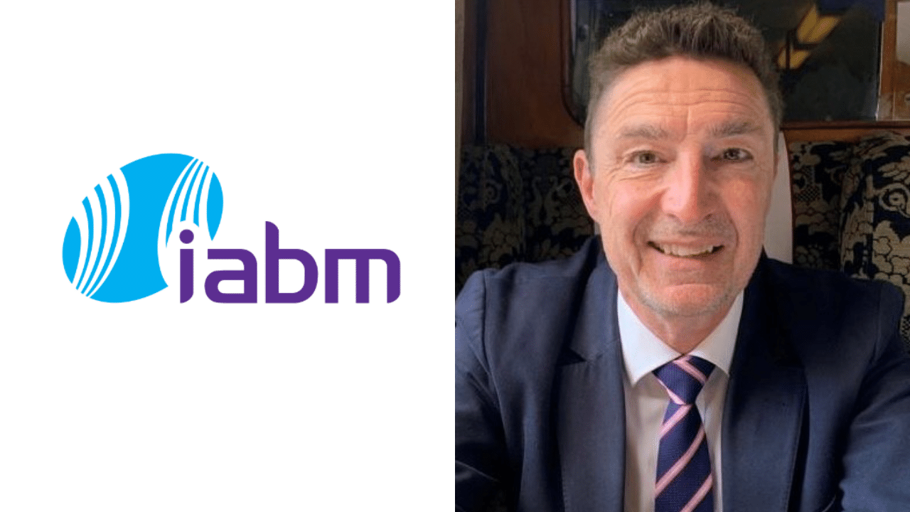 The IABM's Darren Whitehead next to the IABM logo