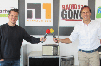 A picture of Alexander Koller and Florian Kerschner. They aere both holding microphones
