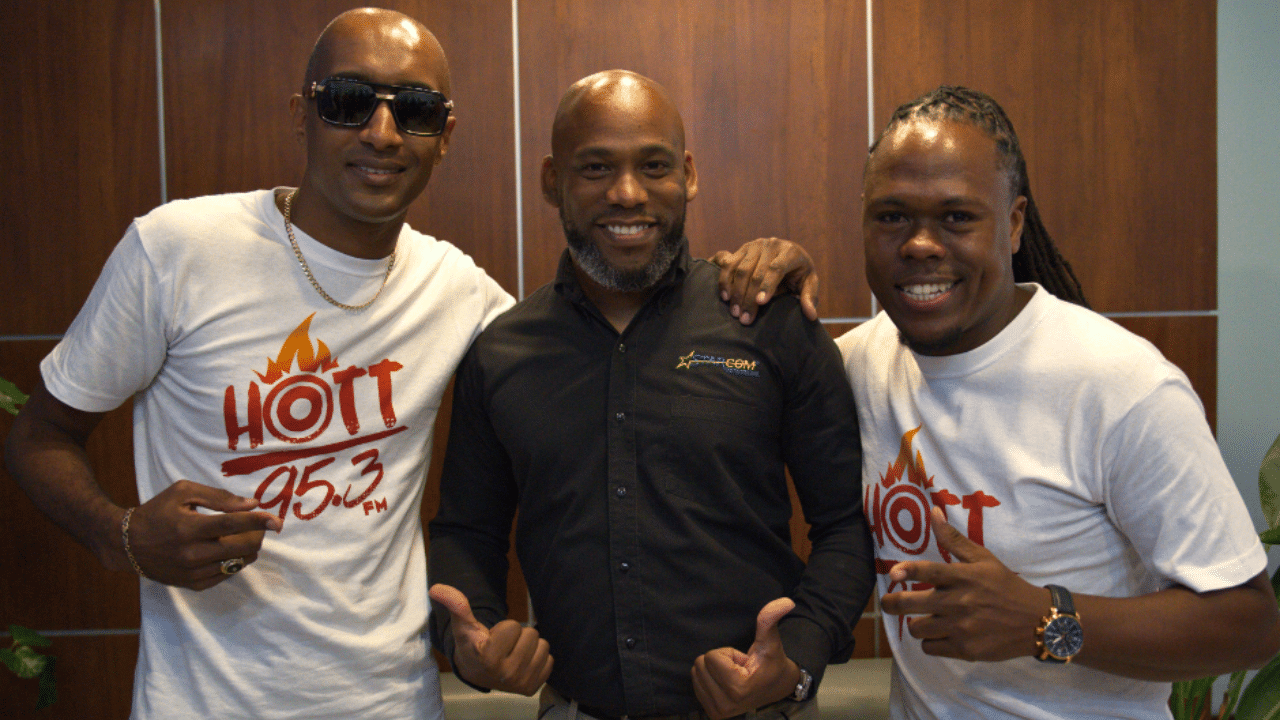 HOTT 95.3 FM Vibez Radio Show DJ Indian, left, and DJ Chris Gayle, right, with the General Manager  of Starcom Network, Anthony Greene
