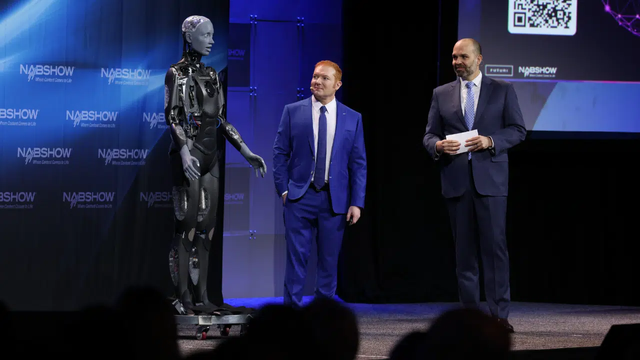NAB President and CEO Curtis LeGeyt, right, with Futuri CEO Daniel Anstandig and Ameca, an autonomously AI-powered humanoid robot.